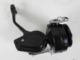 a close up of a fishing reel on a white surface