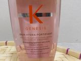 the bottle of kerastasee is sitting on top of a basket