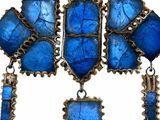 an image of a close up of a necklace with blue stones