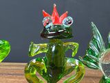 three glass figurines sitting on a wooden table