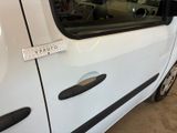 a white van with a sticker on the side of it ' s door