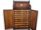 an image of a wooden chest of drawers with a door open