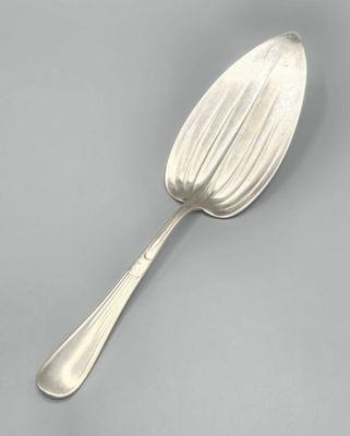 silver spoon on a gray surface with a silver spoon in the middle