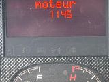 a digital clock on the dashboard of a car