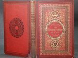 two books with red covers and gold trims on them