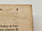 an old book with writing on it sitting on a table