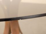 a close up of a glass table with a wooden base