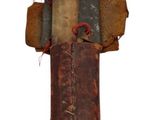 a rusted cross on a pole with wires attached to it