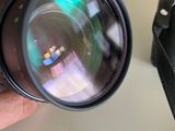 a person holding a camera with a lens in their hand