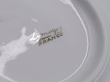a close up of a white plate with a logo on it
