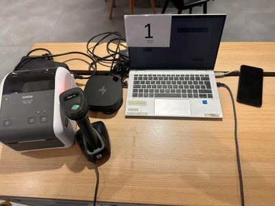 a laptop and a printer sitting on a table