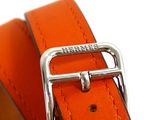 a close up of an orange belt with a metal buckle