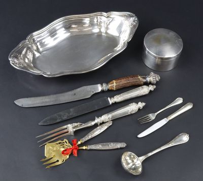a silver plate with a knife, fork, spoon, and other silverware