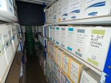 many boxes that are stacked on the shelves in the room
