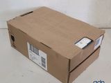 a cardboard box with a label on it sitting on the floor