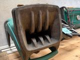 a green and black toaster sitting on a wooden table