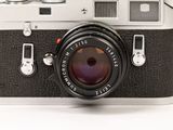 a black and white photo of a camera with a lens