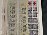 a picture of a book with stamps and a red cross on it
