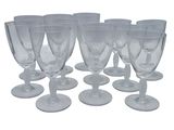 six clear wine glasses sitting on top of each other on a white surface