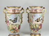 pair of vases decorated with birds and flowers on a white background
