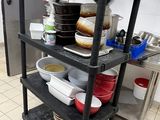 a black cart with dishes on it in a kitchen