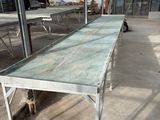 a long table with a glass top inside of a building