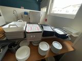 many plates and pans on the counter in the kitchen