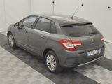 a grey car parked in a garage with a checkered floor