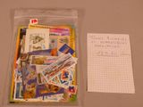 a bag of stamps and a piece of paper on a table