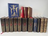 several old books are stacked on top of each other on a table