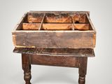 an old wooden table with a drawer on top of it