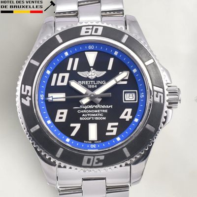 a close up of a wrist watch with a blue face
