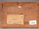 an old brown box with a piece of paper on top of it