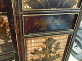a tall cabinet that has a flower design on it