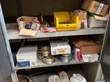 a metal shelf with boxes and other items on it