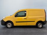 the yellow van is parked in a parking lot on a cloudy day