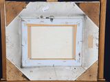 an old picture frame sitting on top of a wooden easel