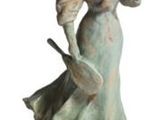a statue of a woman with a hat and a cane