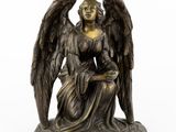 an image of a bronze statue of an angel holding a child