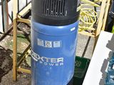 a blue and black air compressor sitting on a pallet