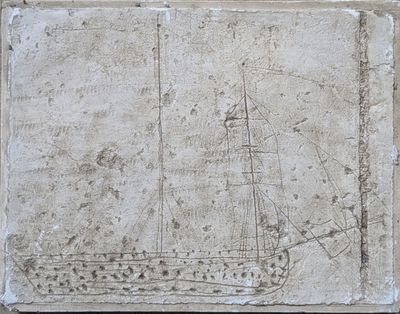 a drawing of a ship on a stone block
