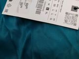 a ticket that is sitting on a bed next to a pillow