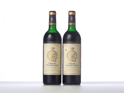 two bottles of wine sitting next to each other on a table