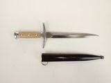 two different types of knives on a white surface