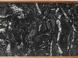 black and white marble in a wooden frame on a white wall
