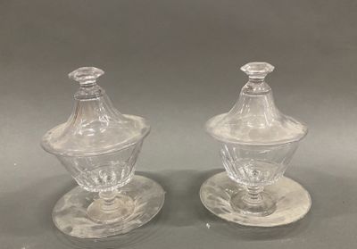 pair of clear glass sugar and pepper shakers on saucers