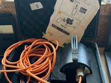 a black case with an orange hose in it on a table