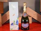 a bottle of champagne sitting next to a box of wine