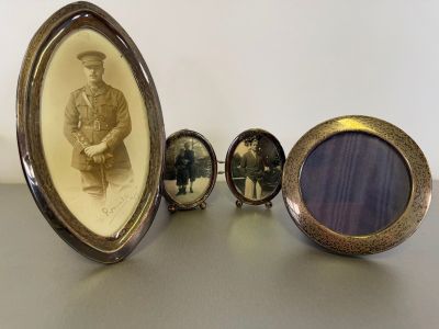 three framed photographs of men in military uniforms are sitting next to each other on a table