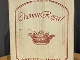 a box of wine sitting on top of a wooden table